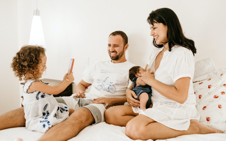 man in white crew neck t-shirt sitting beside woman in white crew neck t-shirt