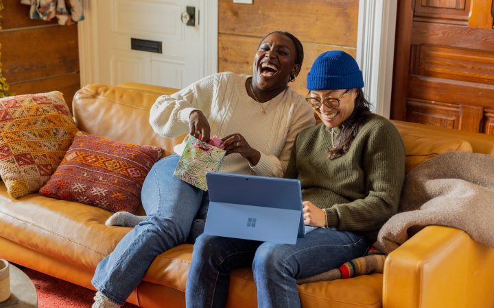 a person sitting on a couch with a laptop